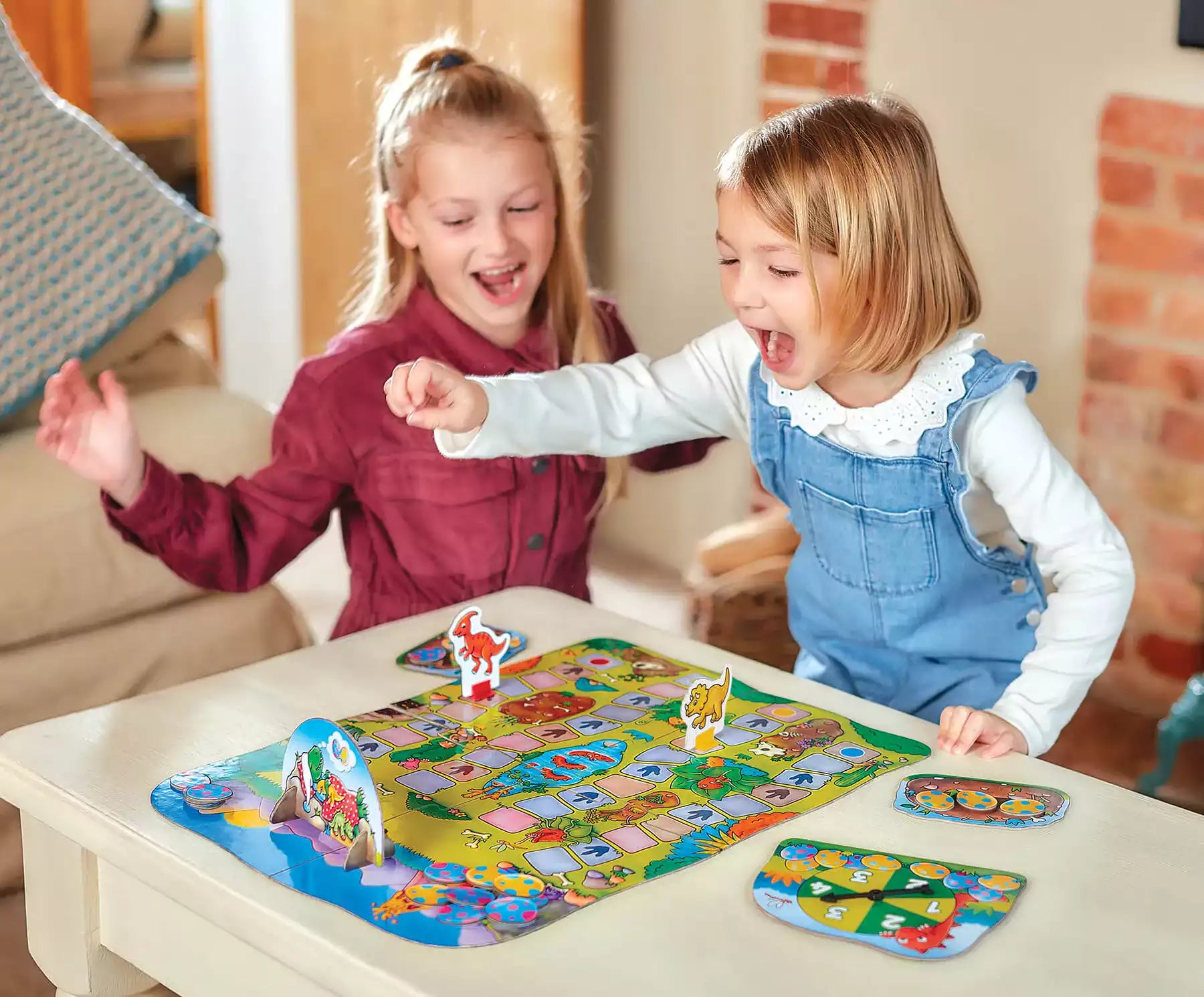 Children playing with Dino-Snore-Us from orchard toys