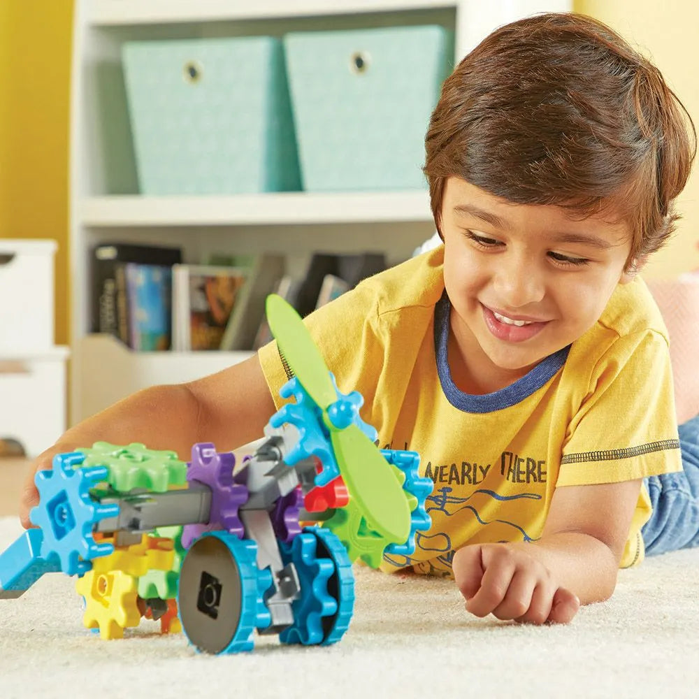 kid playing with flight gears stem toy - learning resources toys