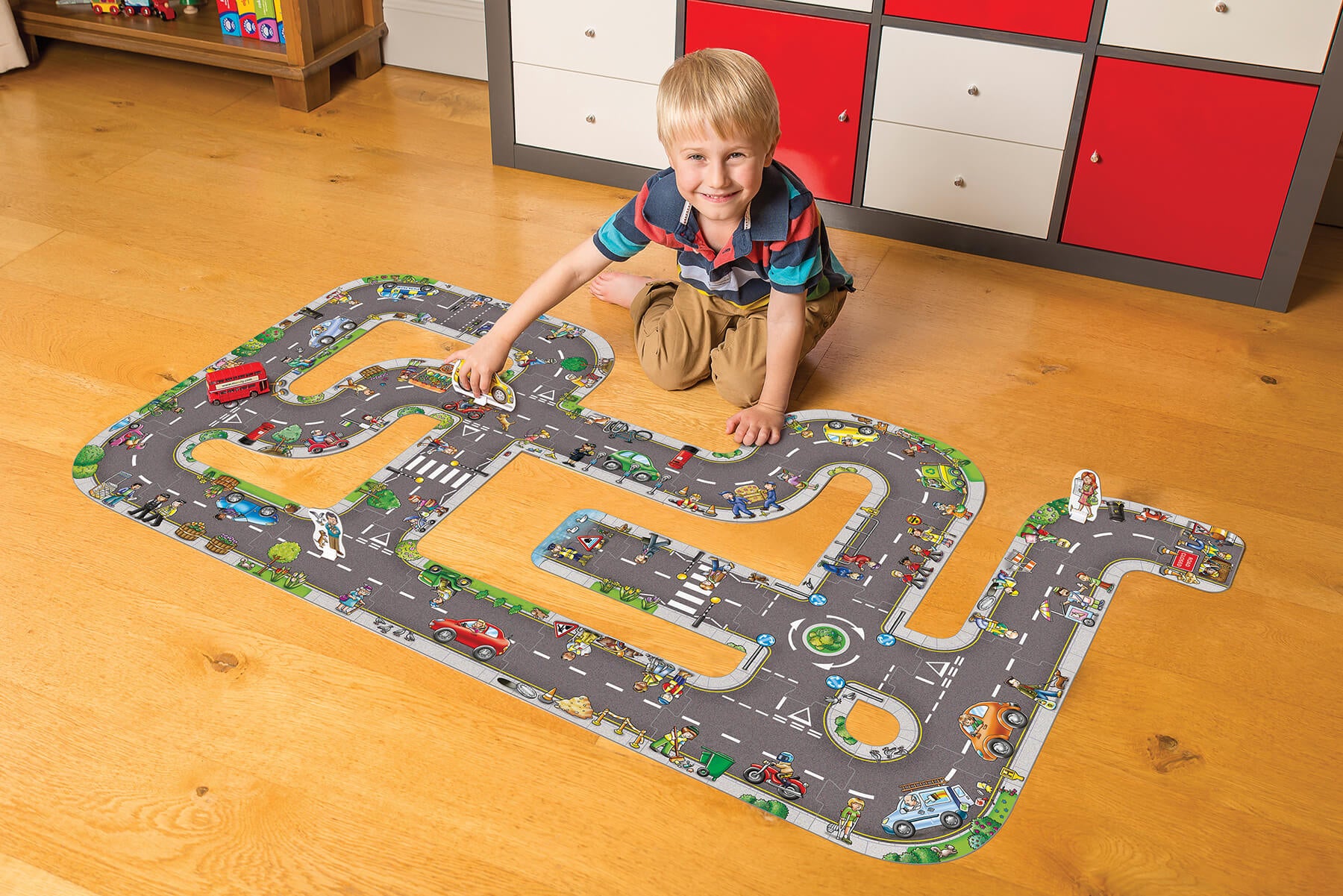 Kid with completed Giant Road Puzzle - orchard toys