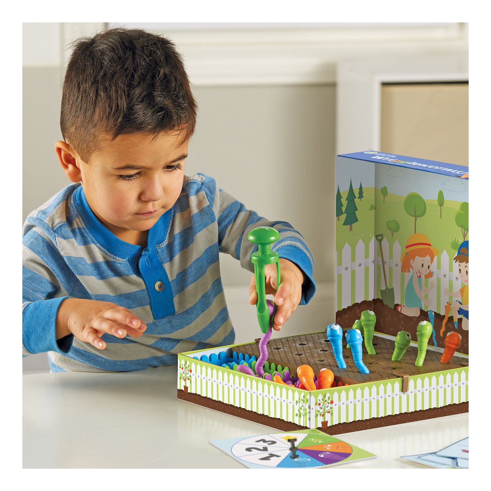 kid playing with wriggleworms game - learning resources toys