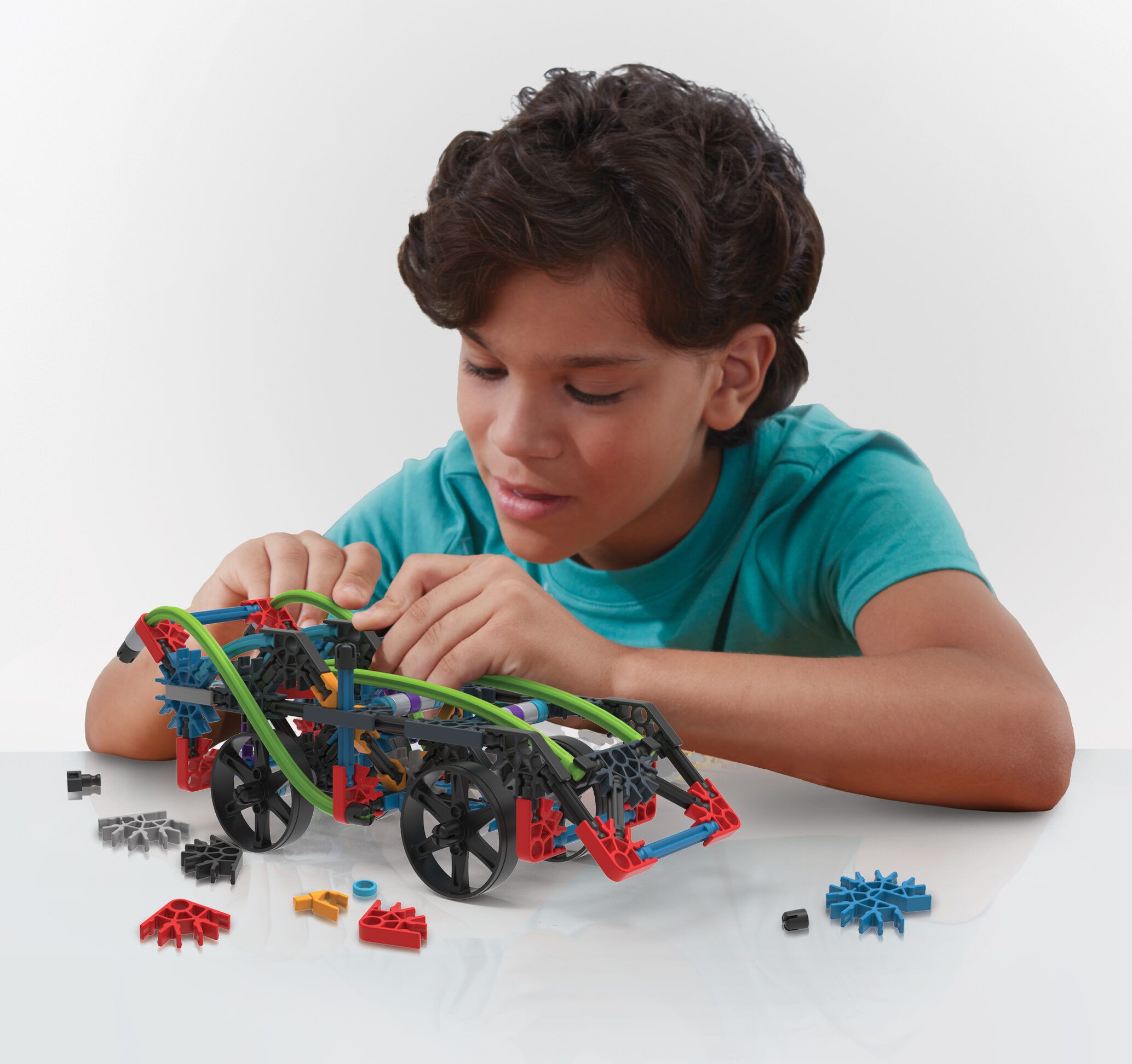 boy playing with rad rides knex set