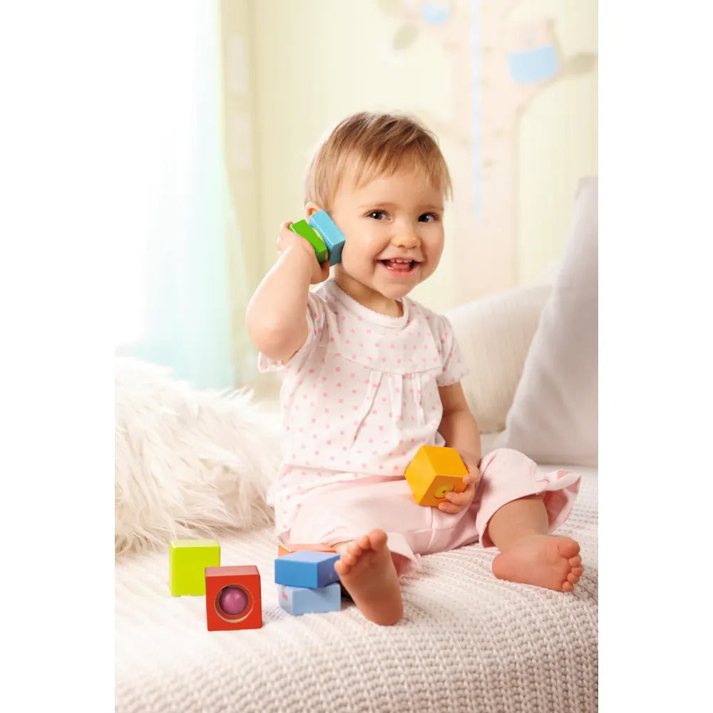 Girl playing with HABA musical toys