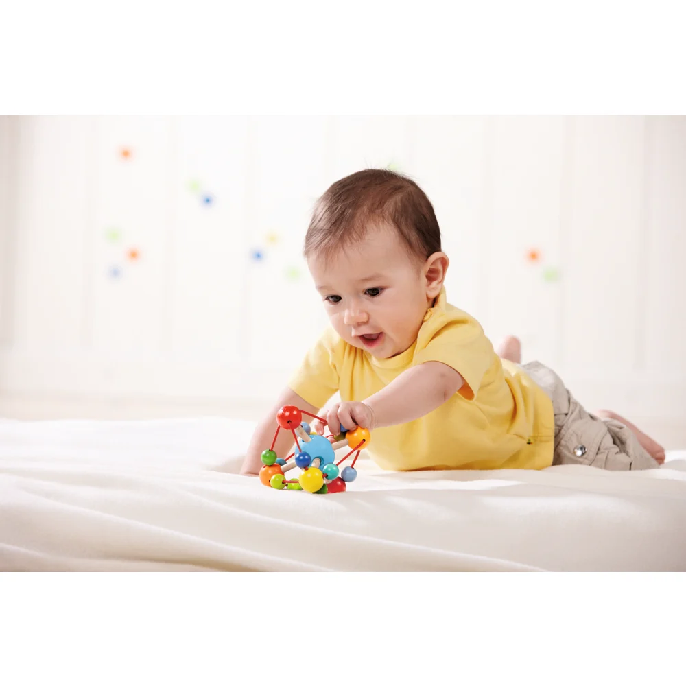 boy playing with clutching toy HABA